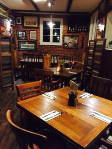 a dining room with wooden tables and chairs at The New Forest Inn in Lyndhurst