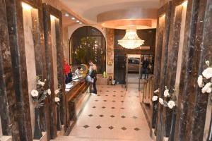a woman standing in the lobby of a restaurant at Indiana Hotel in Cairo