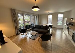 a living room with a couch and a table at Máchovo jezero apartmán J&J in Doksy