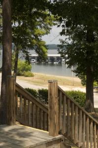 a wooden bridge with a view of a lake at Mountain Harbor Queen Guest Room on Lake Ouachita in Mount Ida