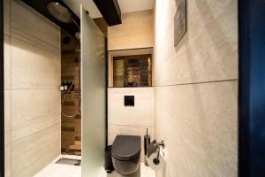 a bathroom with a black toilet and a shower at Mister Highland Hotel in Amsterdam