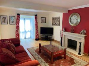 a living room with a couch and a fireplace at 2-Bedroom Cottage with 2 Ensuites - Sleeps 6 Wifi in Rye