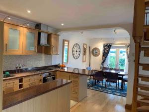 a kitchen with wooden cabinets and a dining room at Stunning 2-Bed cottage Rye East Sussex in Rye