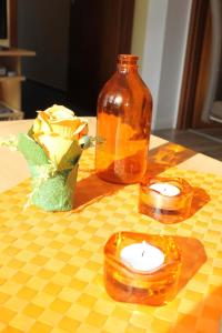 two candles on a table with a vase and flowers at "Haus Sonnenschein - Whg 3" familiengerechte Wohnung mit 2 SZ und Terrasse in zentraler Lage in Grömitz