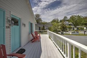 a porch with two red chairs on a house at 528 Candlelight Ln, Bethany Beach in Bethany Beach