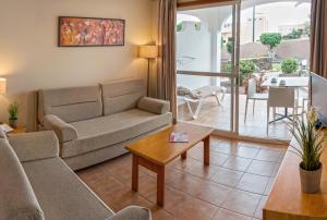 a living room with a couch and a table at Sotavento Beach Club in Costa Calma