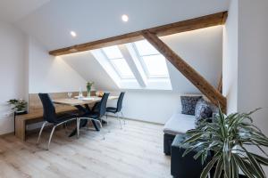 a dining room with a table and chairs and a window at Apartments Repinc in Bled