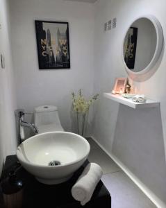 a white bathroom with a sink and a mirror at Deluxe boutique lodge in Vara Blanca