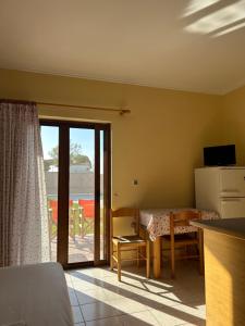 a room with a room with a table and a kitchen at Dimitra Rooms in Lefkada