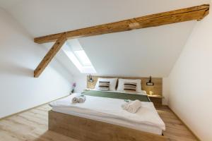 a bedroom with a large bed in a attic at Apartments Repinc in Bled