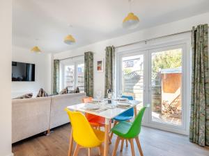 a dining room with a table and chairs and a couch at Garway Cottage in Ross on Wye