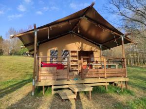 a large gazebo with a roof in a field at Domaine de la Clauzade in Saint-Germain-les-Vergnes