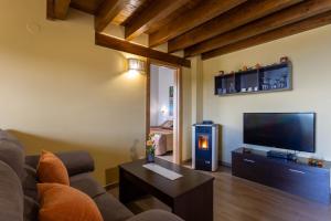 a living room with a couch and a flat screen tv at Villas Verdemar in Isla