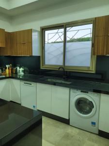 a kitchen with a washing machine and a window at vacances luxe in Marrakesh