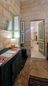 a kitchen with a counter and a room with a door at Myrtle Suite - Valletta ground floor apartment in Valletta