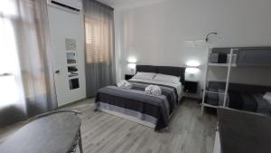Postel nebo postele na pokoji v ubytování Ciccina Rooms