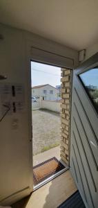 a door to a garage with a view of a yard at Studio Zen in Niort