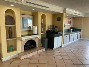 a kitchen with a fireplace in the middle of a room at Econo Lodge in Kalamazoo