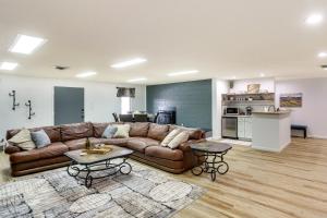 a living room with a brown couch and two tables at Rapid City Apartment with Mountain Views! in Rapid City