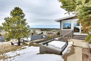 a house with a balcony with snow on the ground at Rapid City Apartment with Mountain Views! in Rapid City