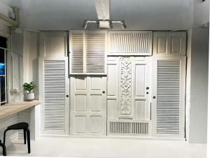 a white door in a room with a window at River Home Bangkok in Bangkok