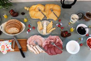 a table topped with different types of bread and meats at Bibi's Boerderij in Veurne