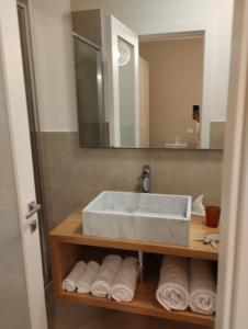 y baño con lavabo, espejo y toallas. en LA LAMPARA, en Carrara