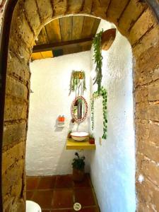 a bathroom with a white wall and a toilet at Cabaña en Malinalco Zarla in Malinalco