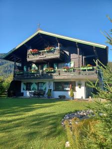 a large house with balconies and flowers on it at Chalet Dr. Datz in Reit im Winkl