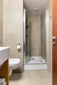 a bathroom with a shower and a toilet at The Central Deluxe in Bucharest