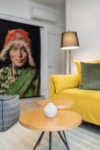a living room with a yellow couch and a table at Aretousa InCreteble Cretan Residences Collection in Sitia