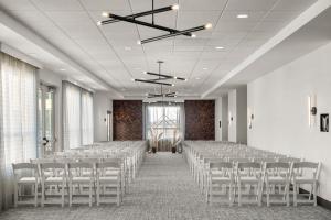 a room with rows of tables and chairs in a room at Courtyard Mankato Hotel & Event Center in Mankato