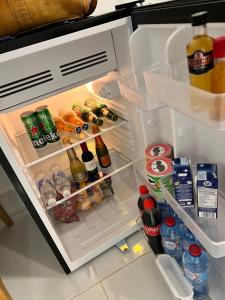 an open refrigerator filled with lots of food and drinks at Casa rosada beach front in Mano Juan