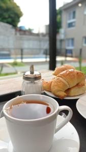 a cup of coffee and croissants on a table at LOS LIRIOS in Puerto Iguazú
