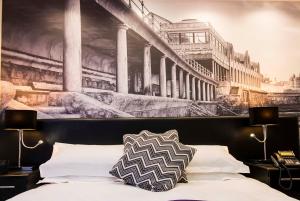 a bedroom with a painting on the wall above a bed at The Mayfield Seamer in Scarborough +44 photos