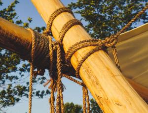 a close up of a wooden pole with ropes at Fronterra Farm- Luxury Camp Experiences in Hillier