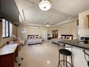Habitación con 2 camas, cocina y sala de estar. en Hotel Casa Libertad, en Santo Domingo
