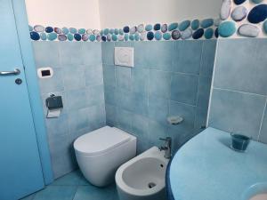 a bathroom with a toilet and a sink at Margiolà Amalfi in Amalfi