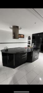 a kitchen with a black counter top in a room at vacances luxe in Marrakesh