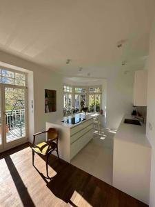 a kitchen with a counter and a chair in a room at Laurelia Suites in Merano