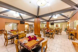 a dining room with wooden tables and chairs at Holiday Inn Austin Midtown by IHG in Austin