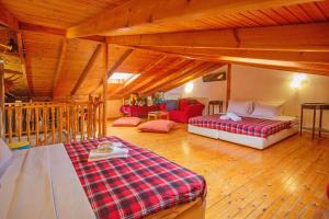 a large room with two beds and a couch at Villa George in Nea Peramos