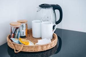 a basket with cups and utensils on a table at Beachside Guesthouse in St Ives
