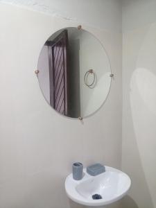 a bathroom with a sink and a mirror on the wall at Pousada Recanto do Mar in Tutóia