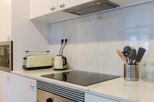 a kitchen counter with a sink and a toaster at Charming Studio in central Lisbon in Lisbon +3 photos