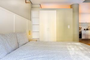 a bedroom with a large bed and a kitchen at Charming Studio in central Lisbon in Lisbon