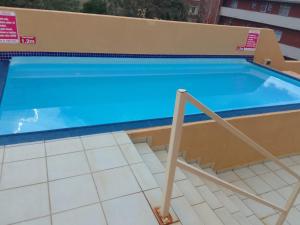 a swimming pool with blue water in a building at Jordy 1 your home away from home in Margate
