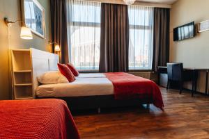 Postel nebo postele na pokoji v ubytování Hotel Renesse