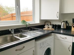 a kitchen with a sink and a dishwasher at Antley House in Andover