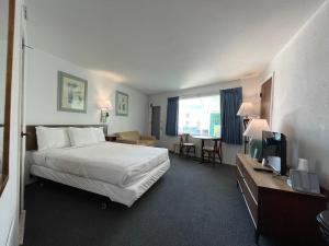 a hotel room with a bed and a television at Bel Air Motel in Wildwood Crest